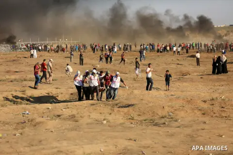 Palestinian protesters gather during clashes with Israeli troops in tents protest where Palestinian demand the right to return to their homeland at the Israel-Gaza border, in east of Gaza City on July 27, 2018. Photo by...