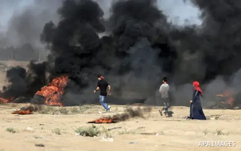 Palestinian protesters gather during clashes with Israeli troops in tents protest where Palestinian demand the right to return to their homeland at the Israel-Gaza border, in east of Gaza City on July 27, 2018. Photo by...