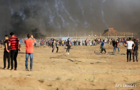 Palestinian protesters gather during clashes with Israeli troops in tents protest where Palestinian demand the right to return to their homeland at the Israel-Gaza border, in east of Gaza City on July 27, 2018. Photo by...