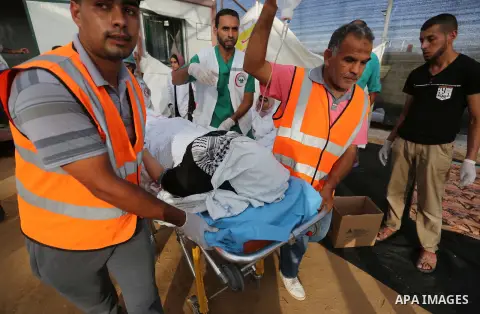 Palestinian protesters gather during clashes with Israeli troops in tents protest where Palestinian demand the right to return to their homeland at the Israel-Gaza border, in Khan Younis, in the southern Gaza Strip on Ju...