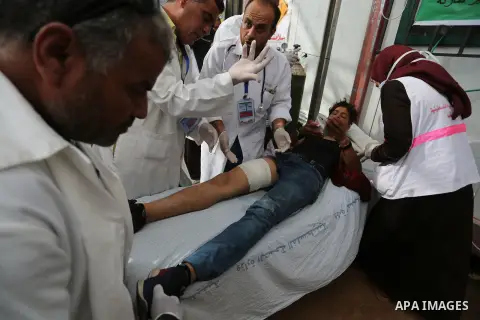 Injured Palestinian protestors receive treatment at a medical tent during clashes with Israeli security forces in tents protest where Palestinian demand the right to return to their homeland at the Israel-Gaza border, in...