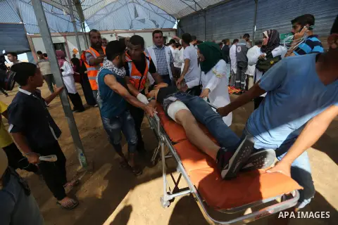 Injured Palestinian protestors receive treatment at a medical tent during clashes with Israeli security forces in tents protest where Palestinian demand the right to return to their homeland at the Israel-Gaza border, in...
