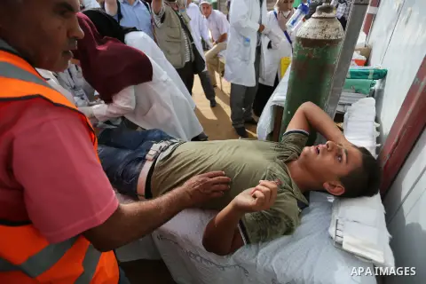 Injured Palestinian protestors receive treatment at a medical tent during clashes with Israeli security forces in tents protest where Palestinian demand the right to return to their homeland at the Israel-Gaza border, in...