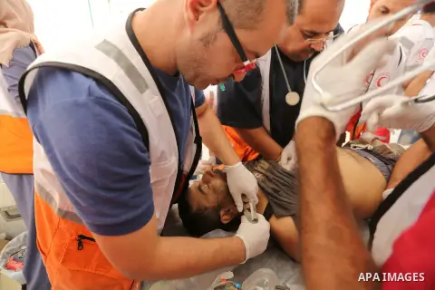 Injured Palestinian protestors receive treatment at a medical tent during clashes with Israeli security forces in tents protest where Palestinian demand the right to return to their homeland at the Israel-Gaza border, in...