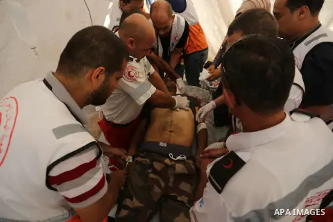 Injured Palestinian protestors receive treatment at a medical tent during clashes with Israeli security forces in tents protest where Palestinian demand the right to return to their homeland at the Israel-Gaza border, in...