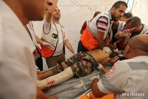 Injured Palestinian protestors receive treatment at a medical tent during clashes with Israeli security forces in tents protest where Palestinian demand the right to return to their homeland at the Israel-Gaza border, in...