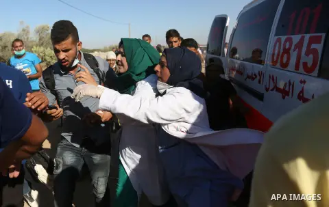 A Palestinian nurse reacts upon seeing the body of her husband who was killed by Israeli troops during clashes in tents protest where Palestinian demand the right to return to their homeland at the Israel-Gaza border, in...