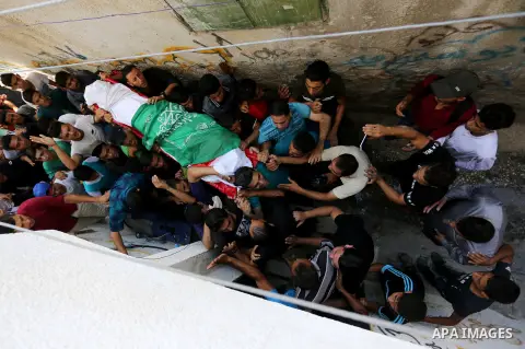 Relatives of Palestinian Mohmen al-Hams, 17, who died of wounds after being shot by Israeli troops during clashes along the border the previous day carry his body during his funeral in the Rafah refugee camp in the south...