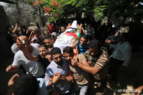 Mourners carry the body of Palestinian Ghazi Abu Mustafa, 43, who was shot dead by Israeli troops during clashes along the border the previous day, carry his body during his funeral in Khan Younis in the southern Gaza St...