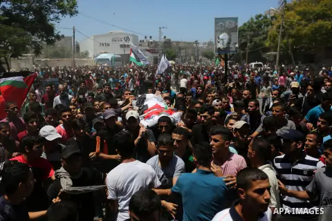 Mourners carry the bodies of Mohmen al-Hams, 17, and Majdi al-Sutari, 11, who were shot dead by Israeli troops during clashes along the border the previous day, during their funeral in Rafah in the southern Gaza Strip on...