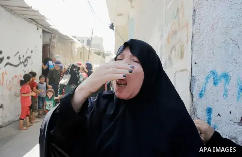 Relatives of Palestinian Majdi al-Sutari, 11, who was shot dead by Israeli troops during clashes along the border the previous day, mourn during his funeral in Rafah in the southern Gaza Strip on July 28, 2018. Photo by...