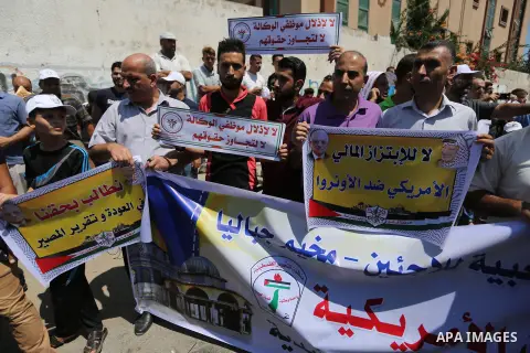 Palestinian employees of United Nations Relief and Works Agency (UNRWA) take part in a protest against job cuts announced by the agency outside its offices in Gaza City on July 29, 2018. Photo by Ashraf Amra