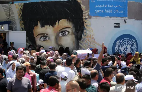 Palestinian employees of United Nations Relief and Works Agency (UNRWA) take part in a protest against job cuts announced by the agency outside its offices in Gaza City on July 29, 2018. Photo by Ashraf Amra