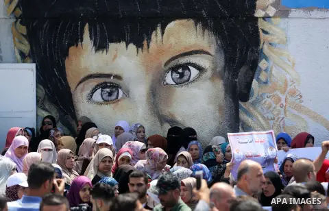 Palestinian employees of United Nations Relief and Works Agency (UNRWA) take part in a protest against job cuts announced by the agency outside its offices in Gaza City on July 29, 2018. Photo by Ashraf Amra