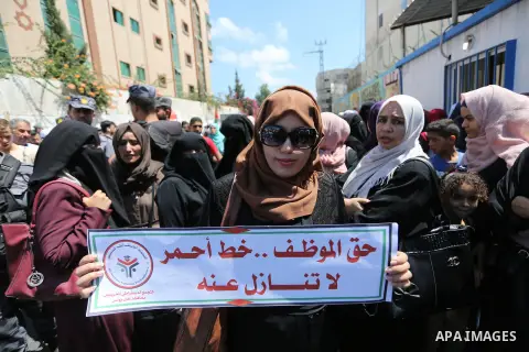 Palestinian employees of United Nations Relief and Works Agency (UNRWA) take part in a protest against job cuts announced by the agency outside its offices in Gaza City on July 29, 2018. Photo by Ashraf Amra
