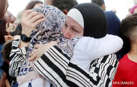 Palestinian activist and campaigner Ahed Tamimi and her mother are welcomed by friends and relatives in the West Bank village of Nabi Saleh near Ramallah on July 29, 2018, upon her release from prison after an eight-mont...