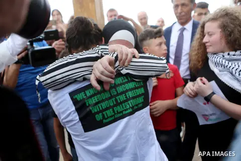 Palestinian activist and campaigner Ahed Tamimi and her mother are welcomed by friends and relatives in the West Bank village of Nabi Saleh near Ramallah on July 29, 2018, upon her release from prison after an eight-mont...