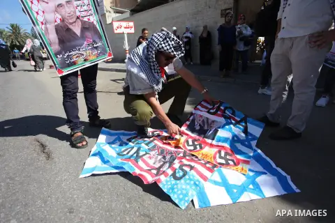 Palestinians burn an Israeli, British and U.S. flags during a protest to show solidarity with Palestinian prisoners held in Israeli jails, in front of Red cross office in Gaza city on July 30, 2018. Photo by Mahmoud Ajou...