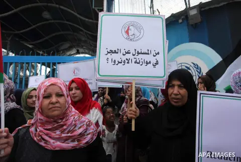 Palestinian employees of United Nations Relief and Works Agency (UNRWA) take part in a protest against a U.S. decision to cut aid, outside its offices, in Gaza City, on Aug. 02 2018. Photo by Mahmoud Ajour