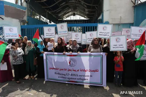 Palestinian employees of United Nations Relief and Works Agency (UNRWA) take part in a protest against a U.S. decision to cut aid, outside its offices, in Gaza City, on Aug. 02 2018. Photo by Mahmoud Ajour