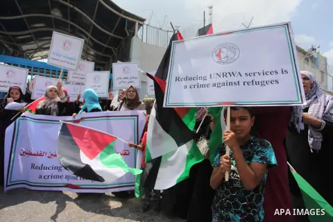 Palestinian employees of United Nations Relief and Works Agency (UNRWA) take part in a protest against a U.S. decision to cut aid, outside its offices, in Gaza City, on Aug. 02 2018. Photo by Mahmoud Ajour