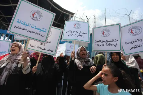 Palestinian employees of United Nations Relief and Works Agency (UNRWA) take part in a protest against a U.S. decision to cut aid, outside its offices, in Gaza City, on Aug. 02 2018. Photo by Mahmoud Ajour