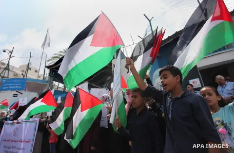 Palestinian employees of United Nations Relief and Works Agency (UNRWA) take part in a protest against a U.S. decision to cut aid, outside its offices, in Gaza City, on Aug. 02 2018. Photo by Mahmoud Ajour