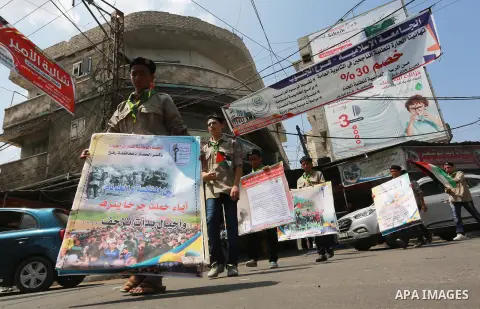 Palestinian scouts take part in a march "The Great Return March", in Rafah in the southern of Gaza strip, on Aug. 02, 2018. Photo by Abed Rahim Khatib