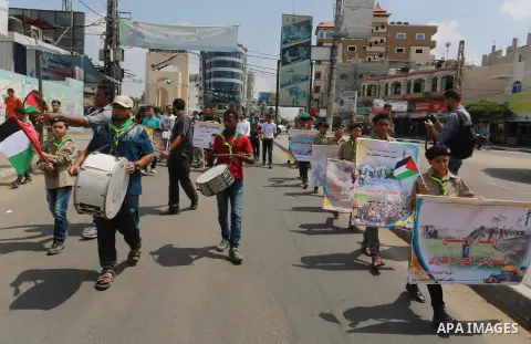 Palestinian scouts take part in a march "The Great Return March", in Rafah in the southern of Gaza strip, on Aug. 02, 2018. Photo by Abed Rahim Khatib