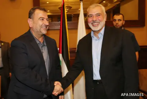 Palestinian Hamas Chief Ismail Haniyeh shakes hands with Hamas Deputy Chief Saleh al-Arouri, in Gaza City August 2, 2018. Hamas Chief Media Office.