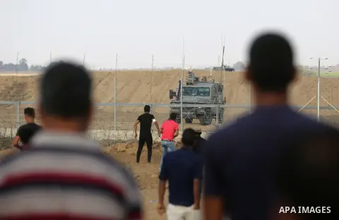 Palestinian protesters gather during clashes with Israeli troops in tents protest where Palestinian demand the right to return to their homeland at the Israel-Gaza border, in Khan Younis, in the southern Gaza Strip on Au...
