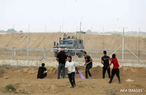 Palestinian protesters gather during clashes with Israeli troops in tents protest where Palestinian demand the right to return to their homeland at the Israel-Gaza border, in Khan Younis, in the southern Gaza Strip on Au...