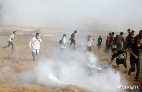 Palestinian protesters gather during clashes with Israeli troops in tents protest where Palestinian demand the right to return to their homeland at the Israel-Gaza border, in Khan Younis, in the southern Gaza Strip on Au...