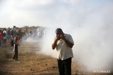 Palestinian protesters gather during clashes with Israeli troops in tents protest where Palestinian demand the right to return to their homeland at the Israel-Gaza border, in Khan Younis, in the southern Gaza Strip on Au...