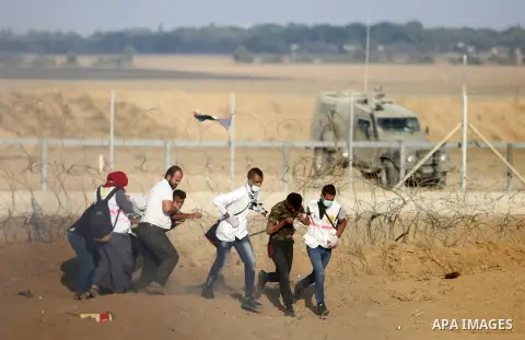 Palestinian protesters gather during clashes with Israeli troops in tents protest where Palestinian demand the right to return to their homeland at the Israel-Gaza border, in Khan Younis, in the southern Gaza Strip on Au...