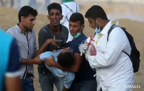 Palestinian protesters gather during clashes with Israeli troops in tents protest where Palestinian demand the right to return to their homeland at the Israel-Gaza border, in Khan Younis, in the southern Gaza Strip on Au...