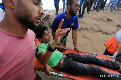 A wounded Palestinian protester is evacuated during clashes with Israeli troops in tents protest where Palestinian demand the right to return to their homeland at the Israel-Gaza border, in al-Bureij, in the center of Ga...