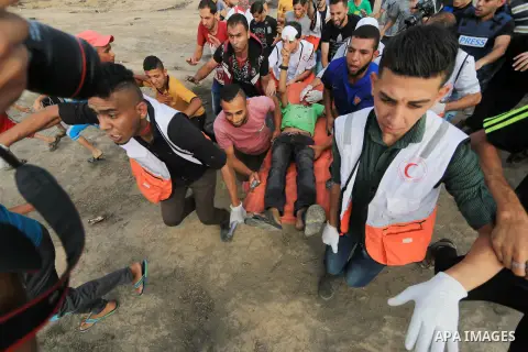 A wounded Palestinian protester is evacuated during clashes with Israeli troops in tents protest where Palestinian demand the right to return to their homeland at the Israel-Gaza border, in al-Bureij, in the center of Ga...