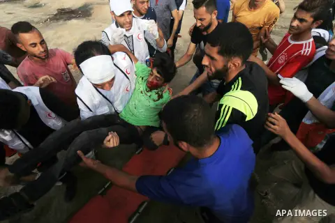 A wounded Palestinian protester is evacuated during clashes with Israeli troops in tents protest where Palestinian demand the right to return to their homeland at the Israel-Gaza border, in al-Bureij, in the center of Ga...