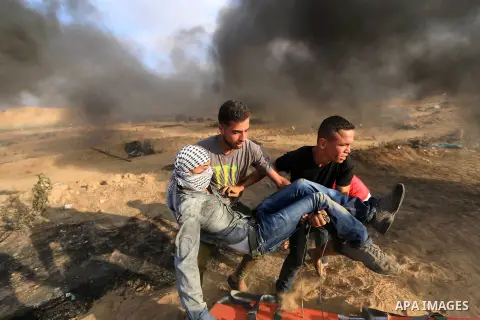 A wounded Palestinian protester is evacuated during clashes with Israeli troops in tents protest where Palestinian demand the right to return to their homeland at the Israel-Gaza border, in al-Bureij, in the center of Ga...