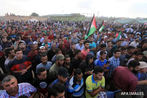 Palestinian protesters gather during clashes with Israeli troops in tents protest where Palestinian demand the right to return to their homeland at the Israel-Gaza border, in al-Bureij, in the center of Gaza Strip on Aug...