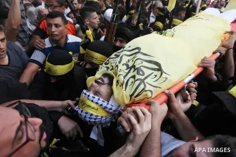 Mourners carry the body of Palestinian Ahmed Yaghi, 25, who was shot dead by Israeli troops during clashes along the border the previous day, during his funeral in Gaza city on Aug. 04, 2018. Photo by Mahmoud Ajour