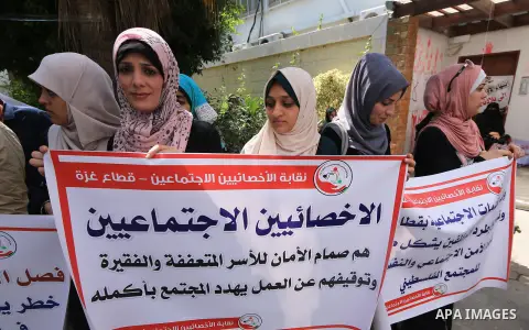 Palestinian employees of United Nations Relief and Works Agency (UNRWA) take part in a protest against a U.S. decision to cut aid, inside its offices, in Gaza City, on Aug. 07 2018. Photo by Mahmoud Khattab