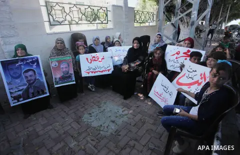 Palestinians take part in a protest to show solidarity with Palestinian prisoners are paid their salaries in Israeli jails in front of the Council of Ministers headquarter in Gaza City, on August 7, 2018. Photo by Mahmou...