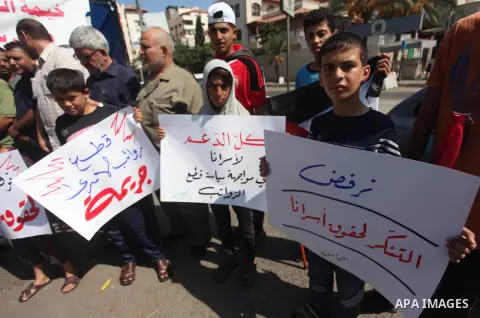Palestinians take part in a protest to show solidarity with Palestinian prisoners are paid their salaries in Israeli jails in front of the Council of Ministers headquarter in Gaza City, on August 7, 2018. Photo by Mahmou...