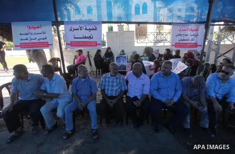 Palestinians take part in a protest to show solidarity with Palestinian prisoners are paid their salaries in Israeli jails in front of the Council of Ministers headquarter in Gaza City, on August 7, 2018. Photo by Mahmou...