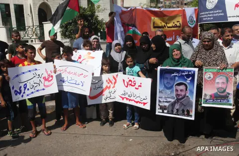 Palestinians take part in a protest to show solidarity with Palestinian prisoners are paid their salaries in Israeli jails in front of the Council of Ministers headquarter in Gaza City, on August 7, 2018. Photo by Mahmou...