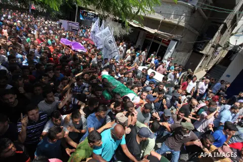 Mourners carry the body of Palestinian Hamas militant Abdel-Hafez al-Silawi who was killed in Israeli tank shelling, during his funeral in Jabaliya, northern Gaza Strip, August 7, 2018. Israeli forces killed two militant...