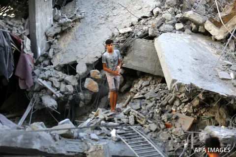 Palestinians inspect the rubble of a building following an Israeli air strike on Gaza City, on August 9, 2018. Photo by Dawoud Abo Alkas