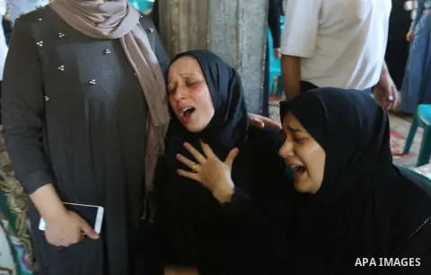 Relatives of Palestinian volunteer medic Abdullah Al-Kotati, who was killed the day before by Israeli troops while trying to help wounded protesters during clashes where Palestinians demand the right to return to their h...